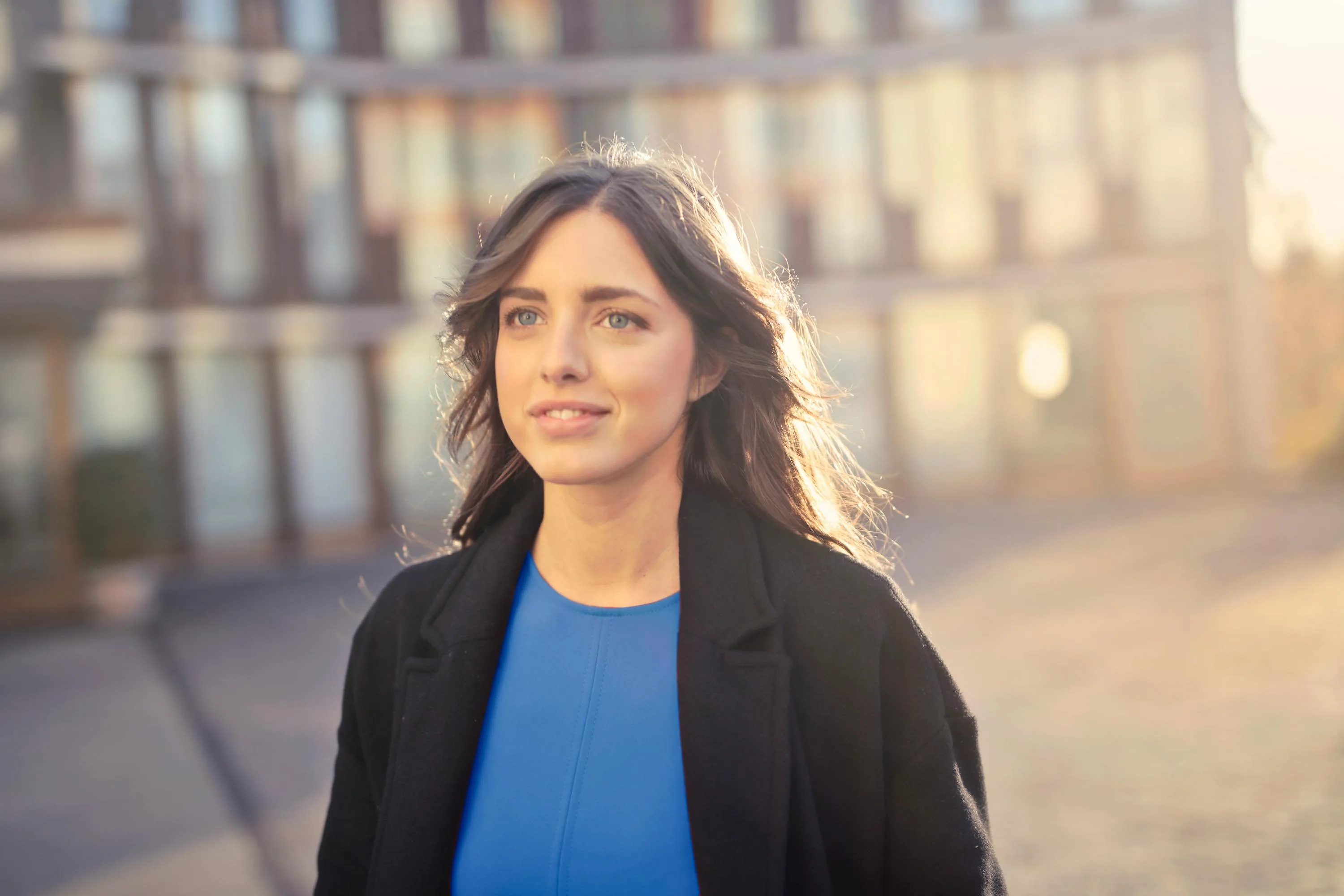 Woman standing outdoors in front of a contemporary building