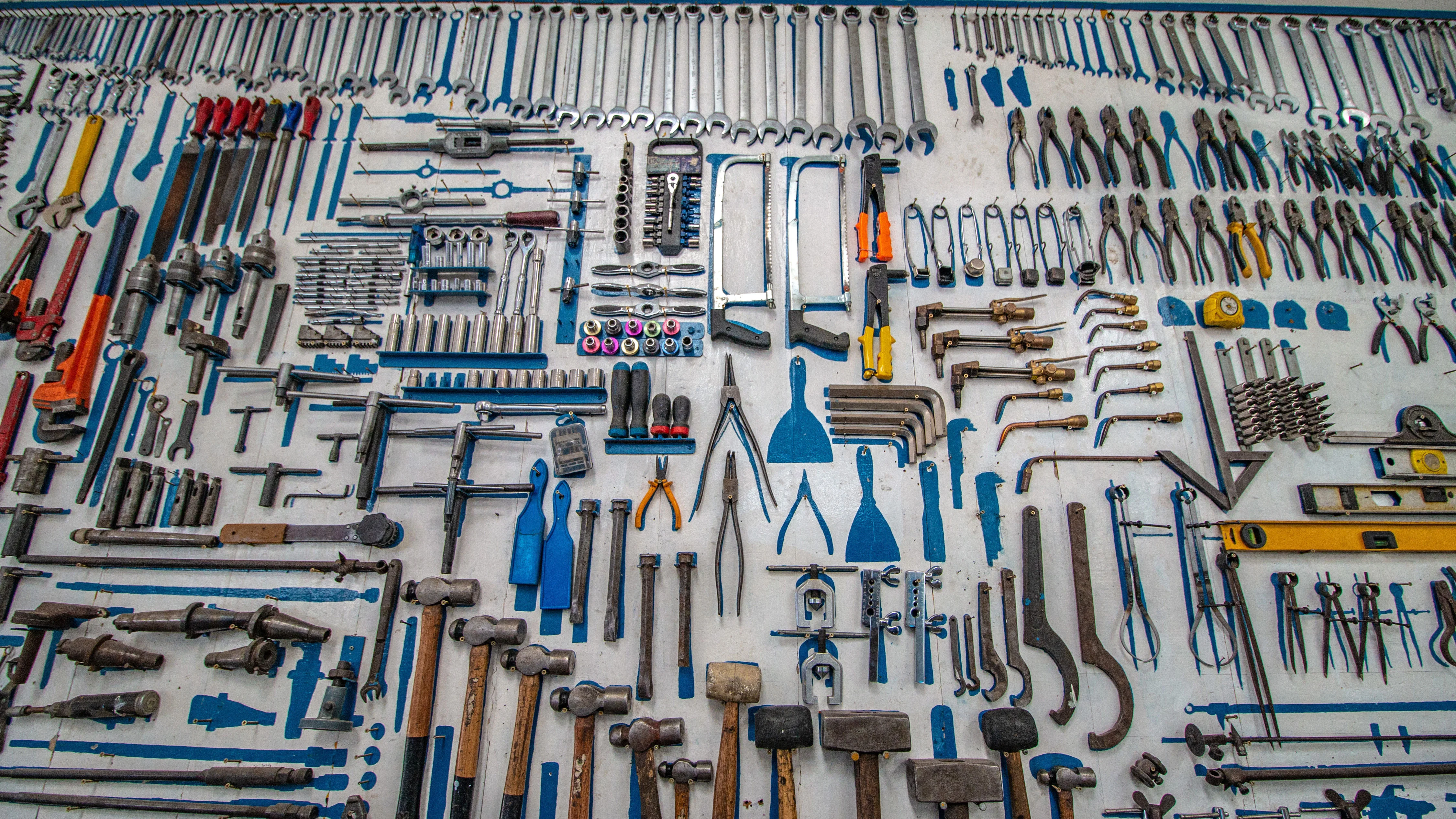 Organized wall of hand tools in a workshop